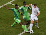 Bosnia-Hercegovina's forward Edin Dzeko fights for the ball with Nigeria's defender Joseph Yobo and Nigeria's defender Kenneth Omeruo during the Group F football match between Nigeria and Bosnia-Hercegovina at the Pantanal Arena in Cuiaba during the 2014 