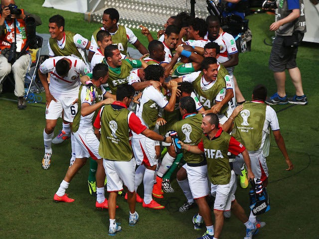 Costa Rica players celebrate after Bryan Ruiz scored their team's first goal during the 2014 FIFA World Cup Brazil Group D match against Italy on June, 20, 2014