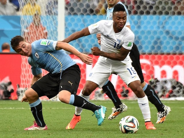 Uruguay's midfielder Cristian Rodriguez (L) vies with England's midfielder Raheem Sterling (R) during a Group D football match on June 19, 2014