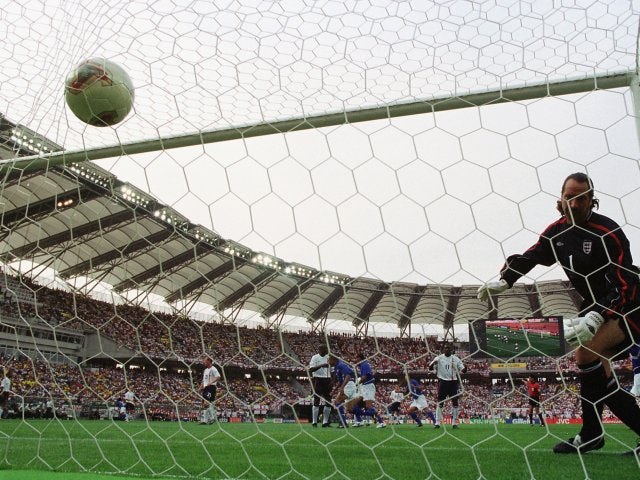 Brazil's Ronaldinho lobs England goalkeeper David Seaman on June 21, 2002.