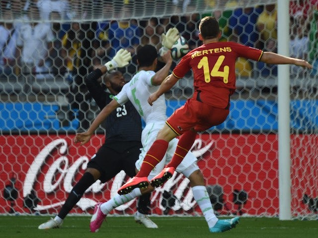 Belgium's forward Dries Mertens (R) scores against Algeria's goalkeeper Rais Mbohli (L) as Algeria's defender Rafik Halliche (C) looks on during a Group H football match on June 17, 2014