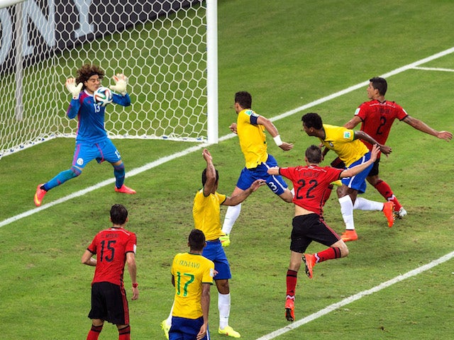 Guillermo Ochoa of Mexico makes a save after a header by Thiago Silva of Brazil during the World Cup Group A match in Fortaleza on June 17, 2014