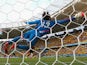 Mexico goalkeeper Guillermo Ocha dives at full stretch to make a save during the World Cup Group A match in Fortaleza against Brazil on June 17, 2014