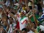 Iran's fans cheer during a Group F football match between Iran and Nigeria at the Baixada Arena in Curitiba at the 2014 FIFA World Cup on June 16, 2014