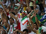 Iran's fans cheer during a Group F football match between Iran and Nigeria at the Baixada Arena in Curitiba at the 2014 FIFA World Cup on June 16, 2014