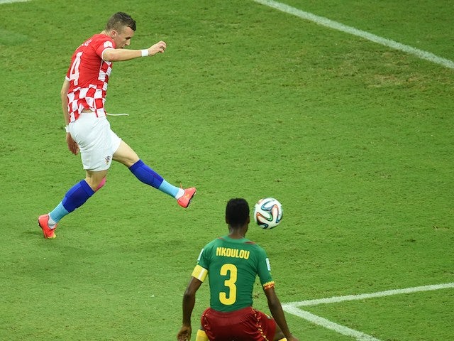 Croatia's midfielder Ivan Perisic (L) kicks to score as Cameroon's defender Nicolas Nkoulou looks on during a Group A football match on June 19, 2014