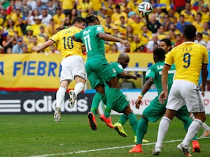 James Rodriguez of Colombia scores his team's first goal ona header against Didier Drogba of the Ivory Coast during the 2014 FIFA World Cup  on June 19, 2014