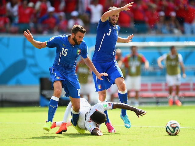 Joel Campbell of Costa Rica falls after a challenge by Giorgio Chiellini (L) and Andrea Barzagli of Italy during the 2014 FIFA World Cup Brazil Group D match on June 20, 2014