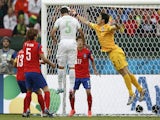 Algeria's defender Rafik Halliche scores in the nets of South Korea's goalkeeper Jung Sung-Ryong during a Group H football match on June 22, 2014