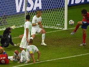 South Korea's forward Koo Ja-Cheol (R) kicks the ball to score his team's second goal during the Group H football match against Algeria on June 22, 2014