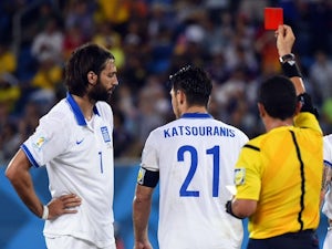 Greece's midfielder Kostas Katsouranis (C) is given the red card after a foul on Japan's midfielder Makoto Hasebe during a Group C football match on June 20, 2014