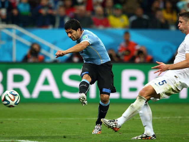  Luis Suarez of Uruguay scores his team's second goal against Gary Cahill of England during the 2014 FIFA World Cup Brazil Group D match  on June 19, 2014