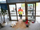 Security personnel stand near broken doors and planters after fans broke through security entering the stadium prior to the 2014 FIFA World Cup Brazil Group B match between Spain and Chile at Maracana on June 18, 2014