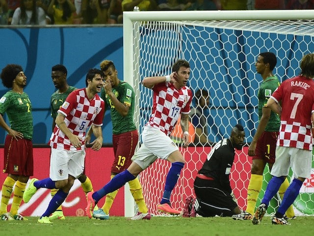 Croatia's forward Mario Mandzukic (C) celebrates his goal during a Group A football match between Cameroon and Croatia in the Amazonia Arena in Manaus during the 2014 FIFA World Cup on June 18, 2014
