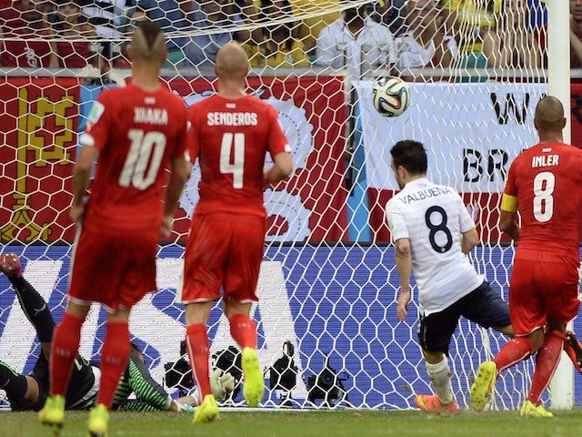 France's midfielder Mathieu Valbuena (2nd R) kicks the ball past Switzerland's goalkeeper Diego Benaglio (back L) to score his team's third goal on June 20, 2014