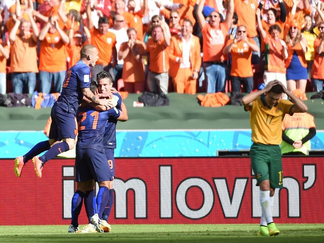 Netherlands' forward Memphis Depay is congratulated after scoring during a Group B football match between Australia and the Netherlands at the Beira-Rio Stadium in Porto Alegre during the 2014 FIFA World Cup on June 18, 2014