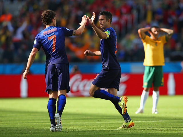 Robin van Persie of the Netherlands celebrates with Daryl Janmaat after scoring the second goal during the 2014 FIFA World Cup Brazil Group B match between Australia and Netherlands at Estadio Beira-Rio on June 18, 2014