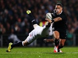 Aaron Smith of New Zealand is tackled by Chris Ashton of England during the International Test match between the New Zealand All Blacks and England at Waikato Stadium on June 21, 2014