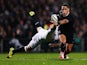 Aaron Smith of New Zealand is tackled by Chris Ashton of England during the International Test match between the New Zealand All Blacks and England at Waikato Stadium on June 21, 2014