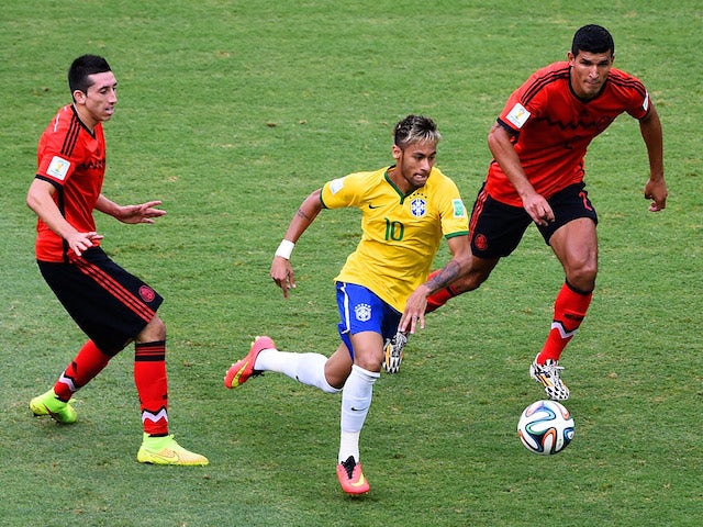 Brazil forward Neymar drives through the Mexico defence during the World Cup Group A match in Fortaleza on June 17, 2014