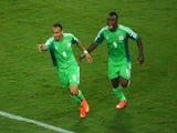Peter Odemwingie of Nigeria celebrates scoring his team's first goal with teammate Emmanuel Emenike during the 2014 FIFA World Cup Group F match between Nigeria and Bosnia-Herzegovina at Arena Pantanal on June 21, 2014