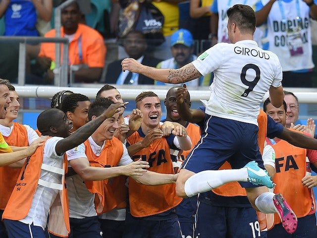 France's forward Olivier Giroud (top R) celebrates scoring his team's first goal during a Group E football match against Switzerland on June 20, 2014