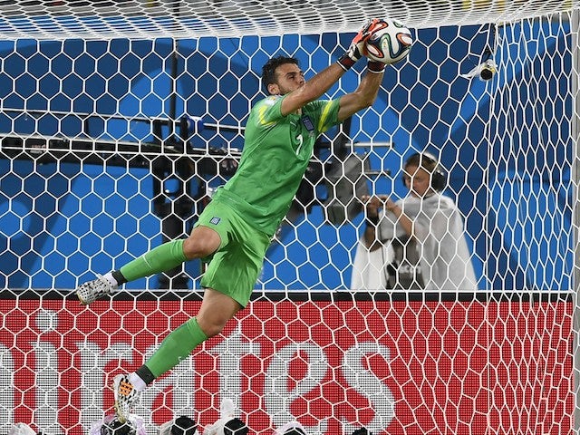 Greece's goalkeeper Orestis Karnezis makes a save during a Group C football match between Japan and Greece at the Dunas Arena in Natal during the 2014 FIFA World Cup on June 19, 2014