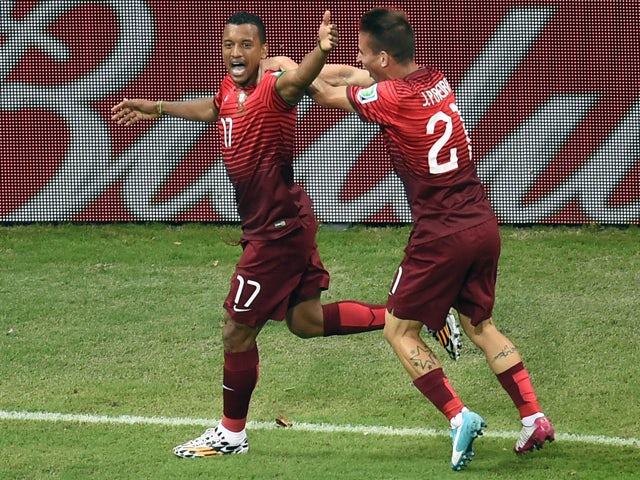 Portugal's forward Nani celebrates with Portugal's defender Joao Pereira after scoring during a Group G football match between USA and Portugal at the Amazonia Arena in Manaus during the 2014 FIFA World Cup on June 22, 2014