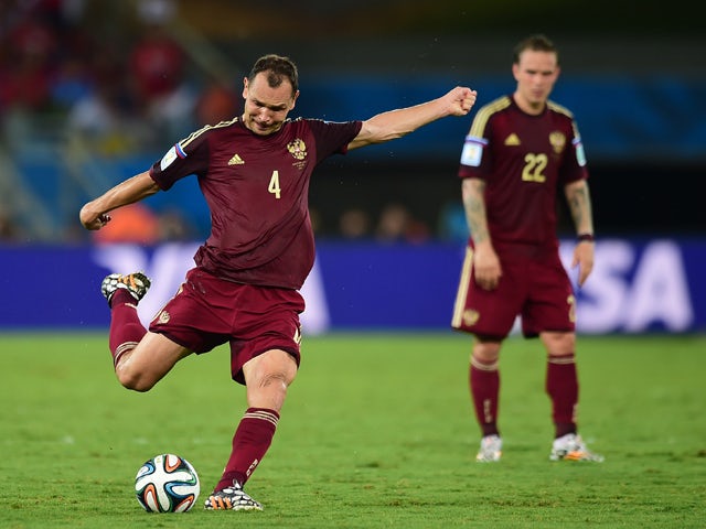 Russia's defender and captain Sergey Ignashevich kicks the ball during a Group H football match between Russia and South Korea in the Pantanal Arena in Cuiaba during the 2014 FIFA World Cup on June 17, 2014