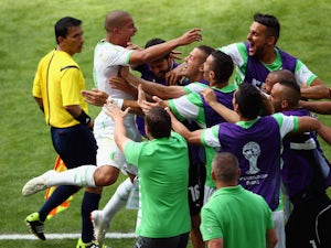 Sofiane Feghouli of Algeria celebrates with his teammates after scoring a penalty during the World Cup Group H match against Belgium in Belo Horizonte on June 17, 2014