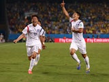 Lee Keun-Ho of South Korea celebrates scoring his team's first goal with Lee Chung-Yong during the 2014 FIFA World Cup Brazil Group H match between Russia and South Korea at Arena Pantanal on June 17, 2014