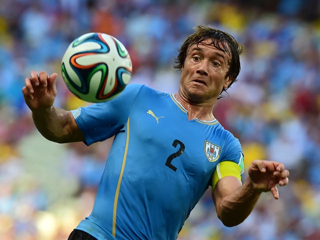 Uruguay's defender Diego Lugano in action during a Group D football match between Uruguay and Costa Rica at the Castelao Stadium in Fortaleza during the 2014 FIFA World Cup on June 14, 2014
