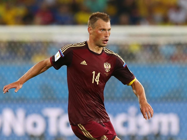 Vasily Berezutskiy of Russia controls the ball during the 2014 FIFA World Cup Brazil Group H match between Russia and South Korea at Arena Pantanal on June 17, 2014