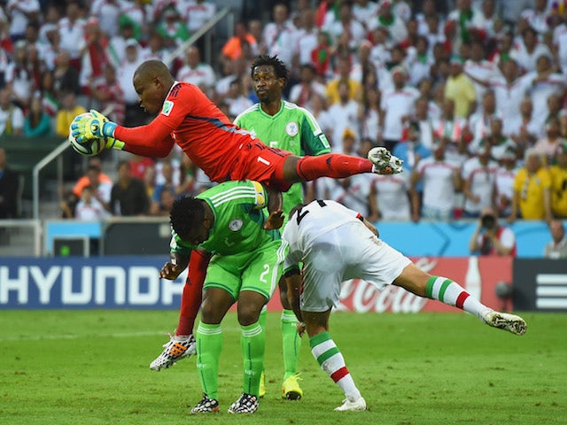 Vincent Enyeama of Nigeria makes a save over teammates Joseph Yobo and Ashkan Dejagah of Iran during the 2014 FIFA World Cup Brazil Group F match on June 16, 2014