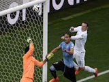 England's forward Wayne Rooney (R) jumps to head the ball during a Group D football match between Uruguay and England at the Corinthians Arena in Sao Paulo during the 2014 FIFA World Cup on June 19, 2014