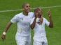 Algeria's midfielder Yacine Brahimi (R) celebrates with defender Madjid Bougherra after scoring his team's fourth goal during the Group H football match against South Korea on June 22, 2014