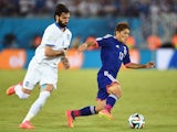 Yoshito Okubo of Japan controls the ball against Giorgos Samaras of Greece during the 2014 FIFA World Cup Brazil Group C match on June 19, 2014