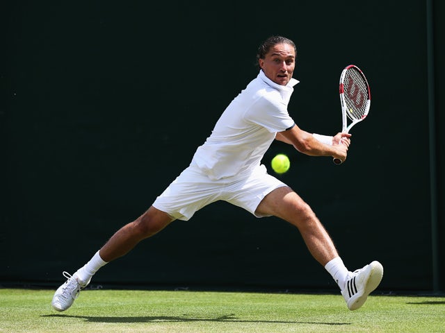  Alexandr Dolgopolov of Ukraine plays a backhand shot during his Gentlemen's Singles second round match against Benjamin Becker of Germany on day three of the Wimbledon Lawn Tennis Championships at the All England Lawn Tennis and Croquet Club at Wimbledon