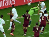 Algeria's forward Islam Slimani heads the ball to score a goal past Russia's goalkeeper Igor Akinfeev during the Group H football match between Algeria and Russia at The Baixada Arena in Curitiba on June 26, 2014