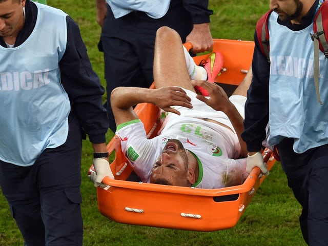 Algeria's forward Islam Slimani is carried off the pitch by stretcher during the Group H football match between Algeria and Russia at The Baixada Arena in Curitiba on June 26, 2014