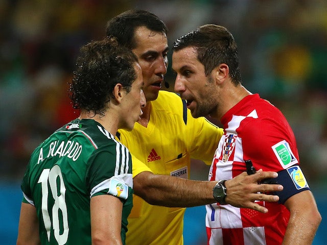 Andres Guardado of Mexico and Darijo Srna of Croatia argue during the 2014 FIFA World Cup Brazil Group A match between Croatia and Mexico at Arena Pernambuco on June 23, 2014
