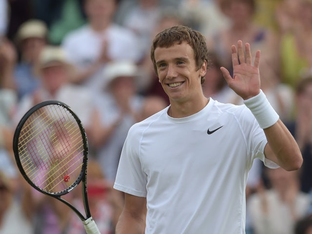 Russia's Andrey Kuznetsov celebrates beating Spain's David Ferrer during their men's singles second round match on day three of the 2014 Wimbledon Championships at The All England Tennis Club in Wimbledon, southwest London, on June 25, 2014