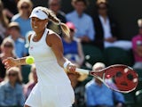 Angelique Kerber of Germany in action during her Ladies' Singles first round match against Urszula Radwanska of Poland on day two of the Wimbledon Lawn Tennis Championships at the All England Lawn Tennis and Croquet Club at Wimbledon on June 24, 2014
