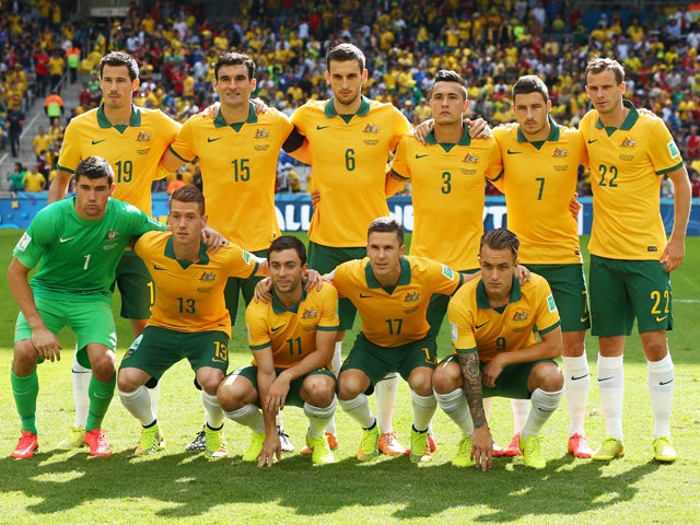 Australia pose for a team photo prior to the 2014 FIFA World Cup Brazil Group B match between Australia and Spain at Arena da Baixada on June 23, 2014