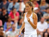 Bojana Jovanovski of Serbia celebrates during her Ladies' Singles second round match against Victoria Azarenka of Belarus on day three of the Wimbledon Lawn Tennis Championships at the All England Lawn Tennis and Croquet Club at Wimbledon on June 25, 2014