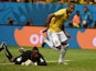 Brazil's midfielder Fernandinho celebrates after scoring their fourth goal as Cameroon's goalkeeper Charles Itandje reacts during the Group A football match between Cameroon and Brazil at the Mane Garrincha National Stadium in Brasilia during the 2014 FIF
