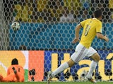 Uruguay's goalkeeper Fernando Muslera fails to save Colombia's midfielder James Rodriguez' (R) shot during the Round of 16 football match between Colombia and Uruguay at the Maracana Stadium in Rio de Janeiro during the 2014 FIFA World Cup in Brazil on Ju