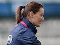 French women's national football team assistant coach Corinne Diacre (L) gives instructions to midfielder Camille Catala during a training session on June 25, 2013