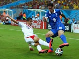  Cristian Gamboa of Costa Rica tackles Lazaros Christodoulopoulos of Greece during the 2014 FIFA World Cup Brazil Round of 16 match between Costa Rica and Greece at Arena Pernambuco on June 29, 2014