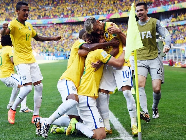 Brazil's defender David Luiz (C) celebrates with teammates after scoring a goal during the round of 16 football match between Brazil and Chile on June 28, 2014